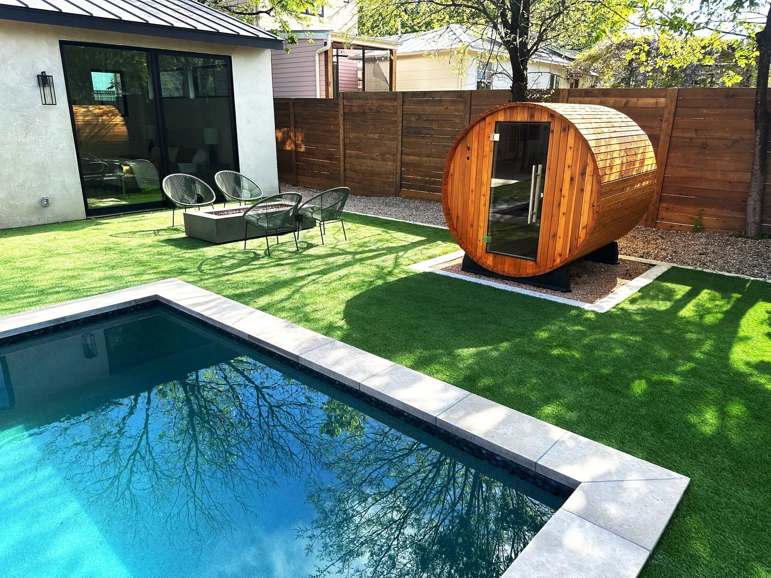 Deep end looking toward a sauna and fire pit