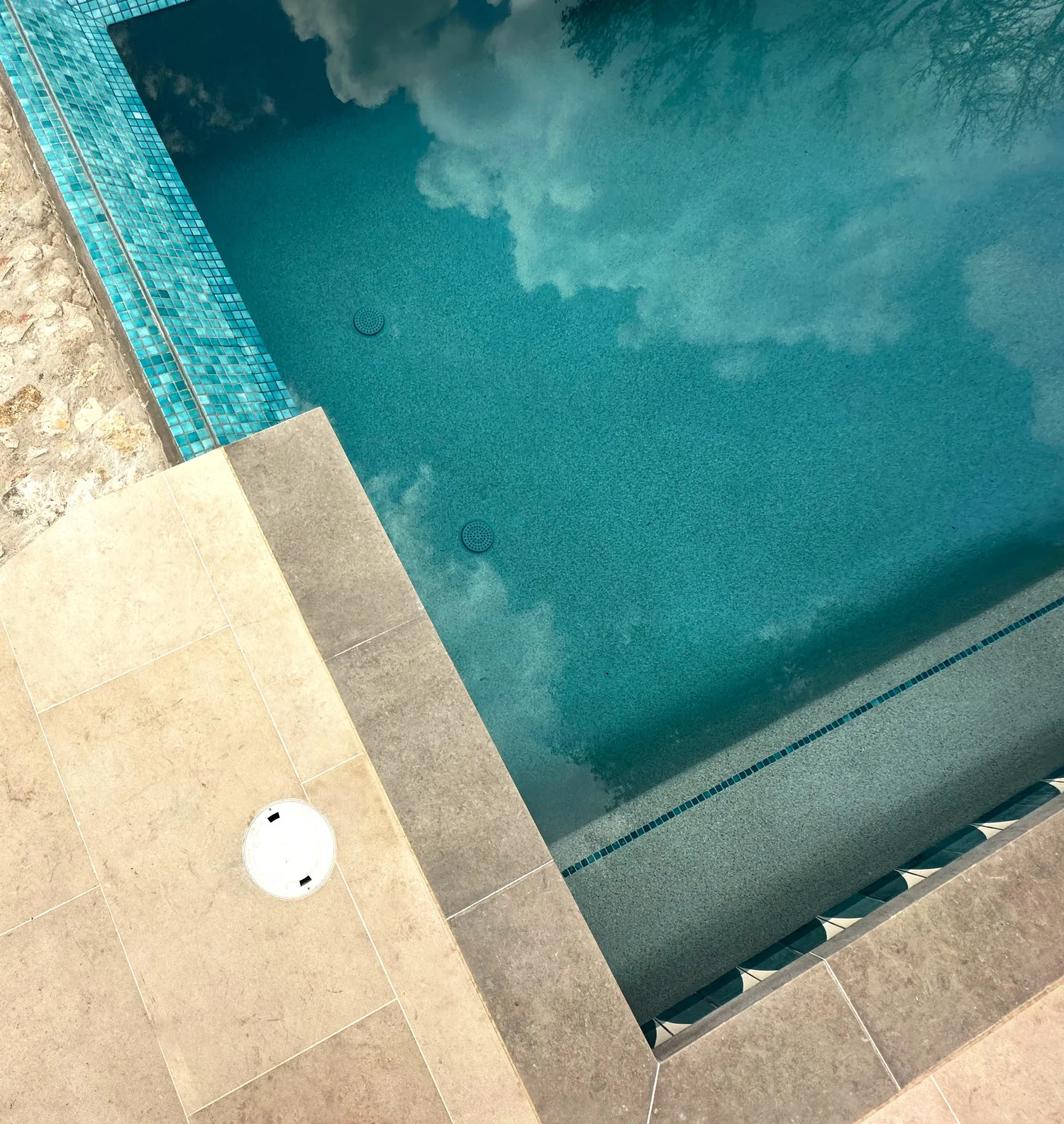 Aerial detail of steps, coping, deck and pool
